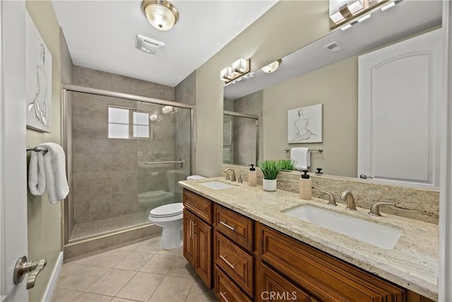 full bathroom with a sink, tile patterned flooring, a stall shower, and toilet