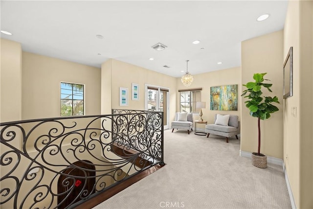 hallway featuring visible vents, baseboards, recessed lighting, a chandelier, and carpet