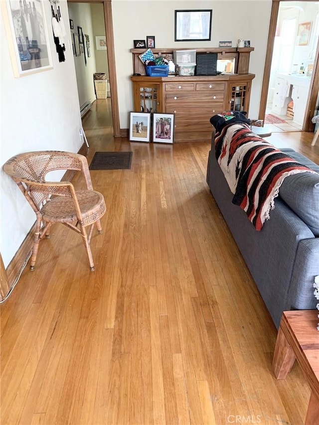 1116 E Appleton St, Long Beach, CA 90802 - living area featuring a baseboard heating unit and light wood finished floors