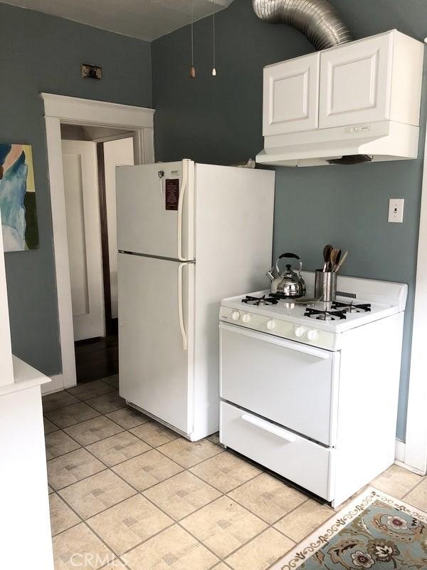 1116 E Appleton St, Long Beach, CA 90802 - kitchen with light tile patterned floors, light countertops, white appliances, and white cabinetry