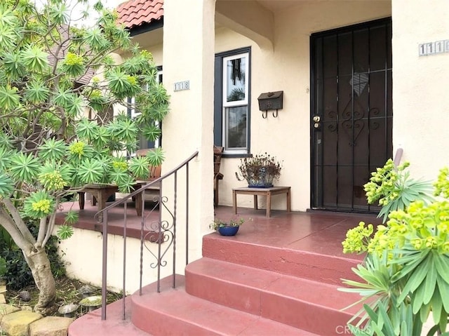 1116 E Appleton St, Long Beach, CA 90802 - property entrance with a porch, stucco siding, and a tiled roof
