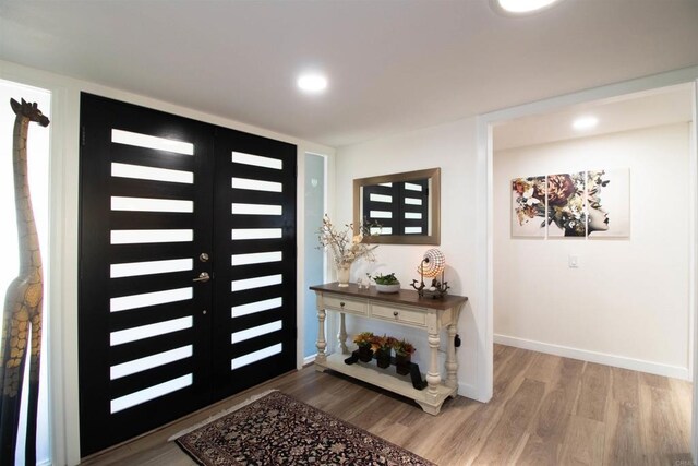entryway featuring baseboards, recessed lighting, and wood finished floors