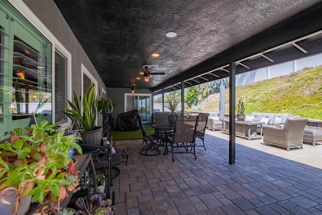 view of patio / terrace featuring ceiling fan, an outdoor living space, and outdoor dining space