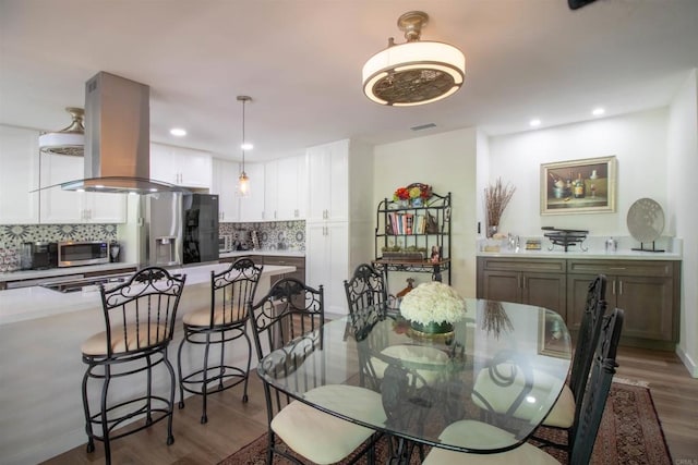 dining area with recessed lighting, visible vents, and wood finished floors