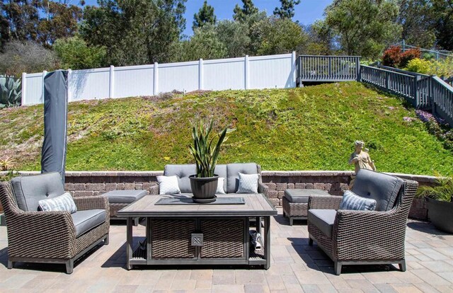 view of patio / terrace with an outdoor living space and a fenced backyard