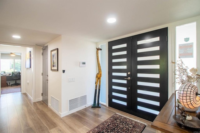 foyer with baseboards, recessed lighting, light wood-style flooring, and visible vents