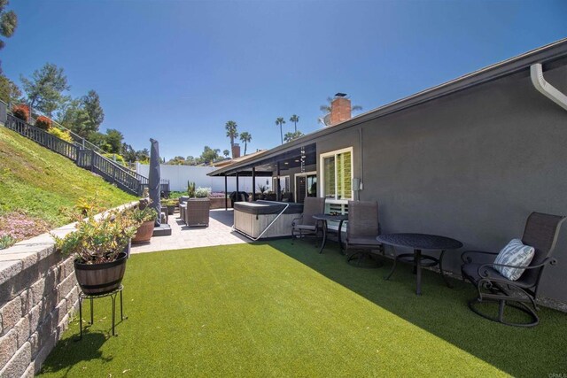 view of yard featuring a fenced backyard, a hot tub, and a patio area