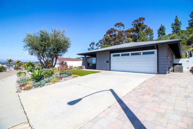 view of front of property with concrete driveway, fence, and a garage