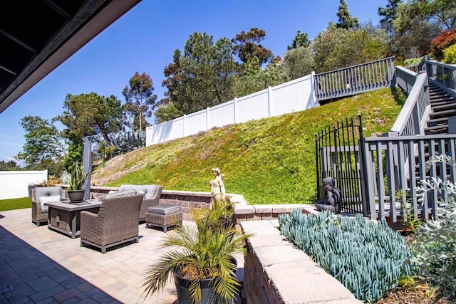 view of patio / terrace featuring stairs, a fenced backyard, and an outdoor hangout area