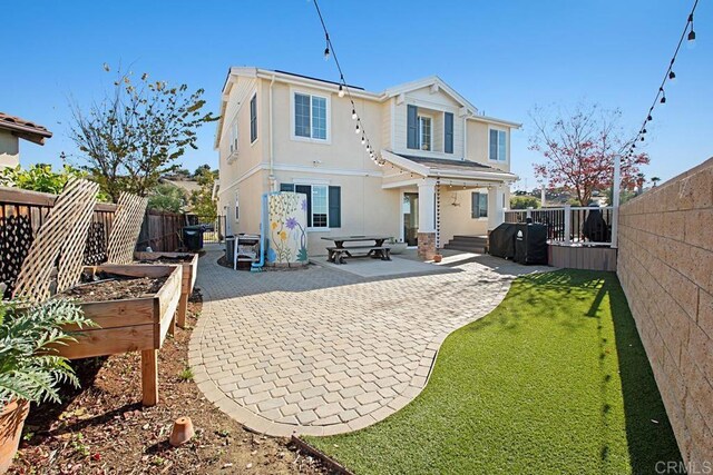 3524 Lone Pine Ln, San Marcos, CA 92078 - rear view of house featuring a fenced backyard, a patio, stucco siding, and a garden