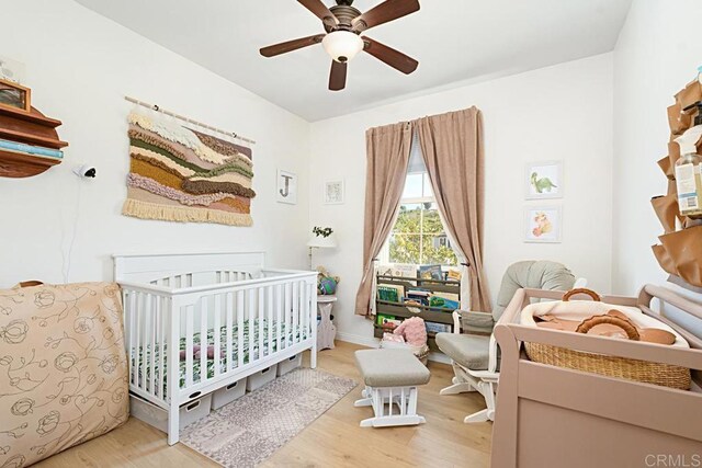 3524 Lone Pine Ln, San Marcos, CA 92078 - bedroom with a crib, ceiling fan, and wood finished floors