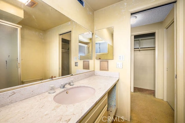 bathroom featuring vanity and a shower stall