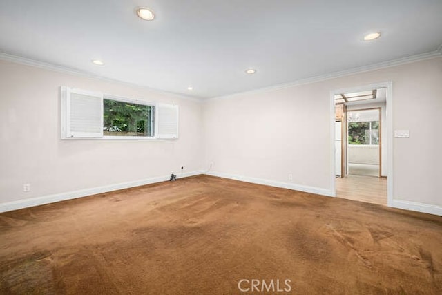 spare room with baseboards, ornamental molding, carpet flooring, and recessed lighting