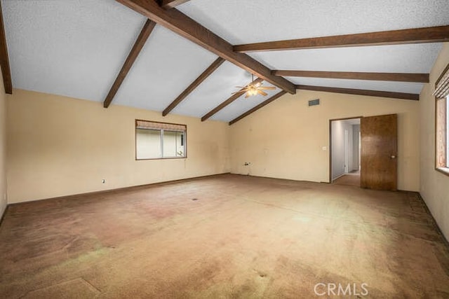 unfurnished room with ceiling fan, light carpet, and vaulted ceiling with beams