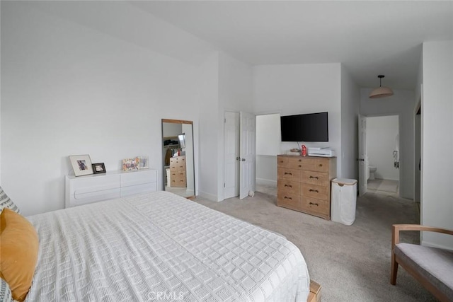 bedroom featuring baseboards and light carpet