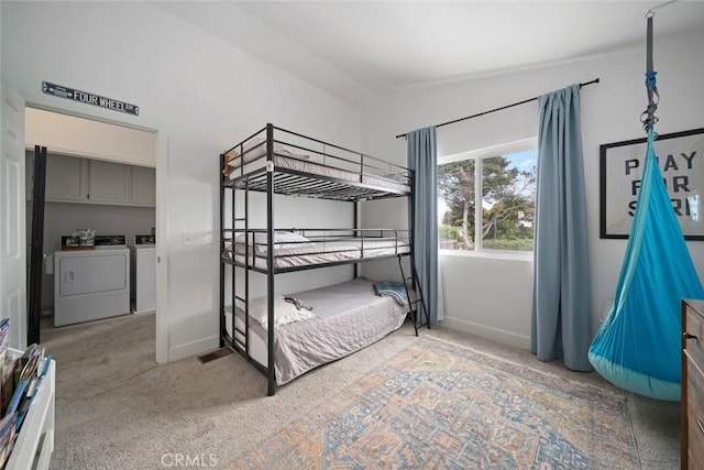unfurnished bedroom with carpet floors, baseboards, and washing machine and dryer
