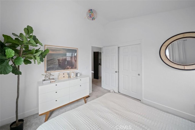 bedroom featuring baseboards, carpet flooring, and vaulted ceiling