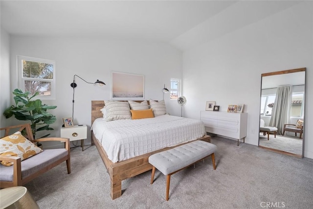 carpeted bedroom featuring vaulted ceiling