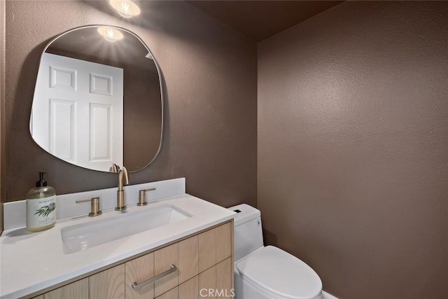 half bathroom with toilet and vanity