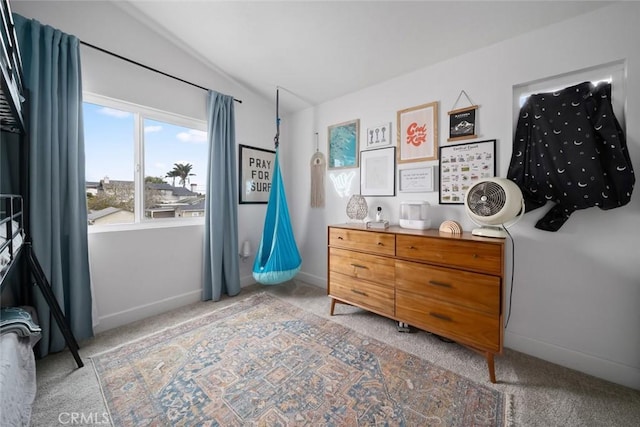 bedroom with baseboards, light carpet, and vaulted ceiling