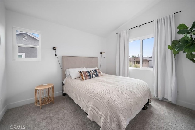 carpeted bedroom featuring baseboards and vaulted ceiling