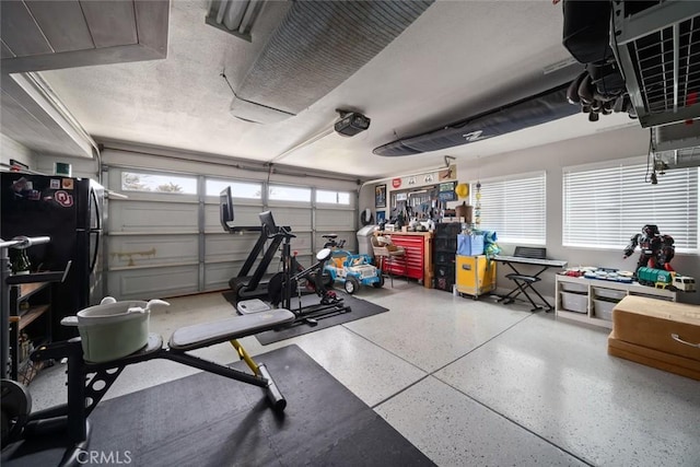 exercise room featuring a workshop area and a garage