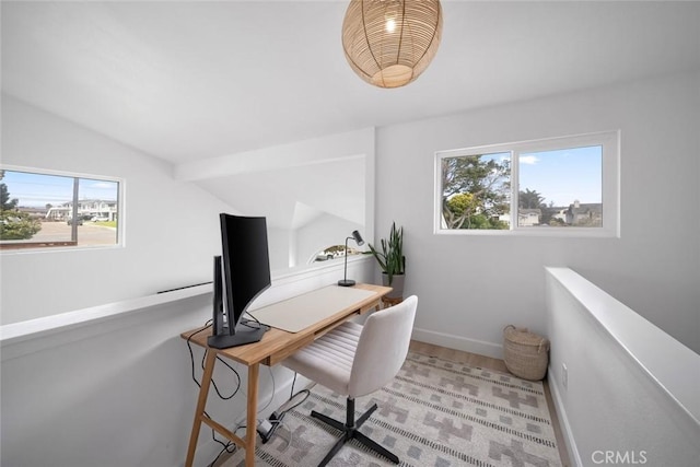 home office with baseboards, plenty of natural light, wood finished floors, and lofted ceiling