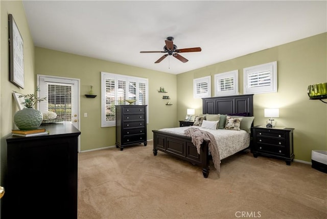 bedroom featuring baseboards, a ceiling fan, and light carpet