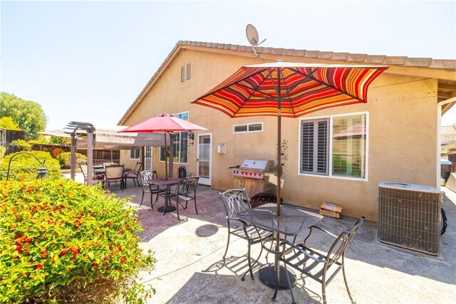 back of property with a pergola, outdoor dining area, a patio, stucco siding, and central air condition unit