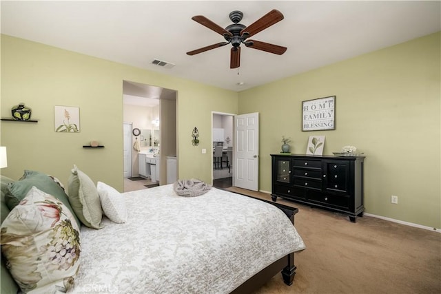carpeted bedroom with baseboards, a ceiling fan, ensuite bath, and visible vents
