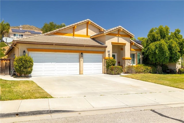 view of front of property with stucco siding, an attached garage, driveway, and a front lawn