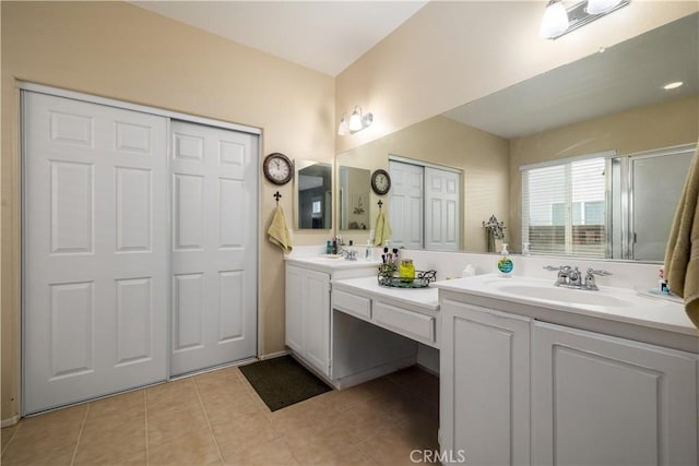 full bathroom featuring double vanity, a sink, and tile patterned floors