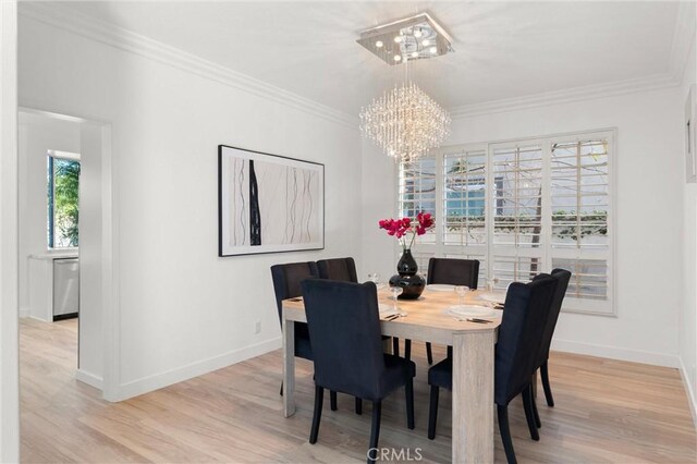 101 Fairlane Rd, Laguna Niguel, CA 92677 - dining space with crown molding, baseboards, light wood-style flooring, and a notable chandelier