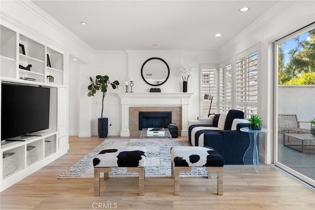 101 Fairlane Rd, Laguna Niguel, CA 92677 - living area with crown molding, a fireplace, built in shelves, recessed lighting, and wood finished floors