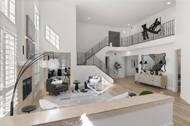 101 Fairlane Rd, Laguna Niguel, CA 92677 - living room featuring stairway, wood finished floors, and a towering ceiling