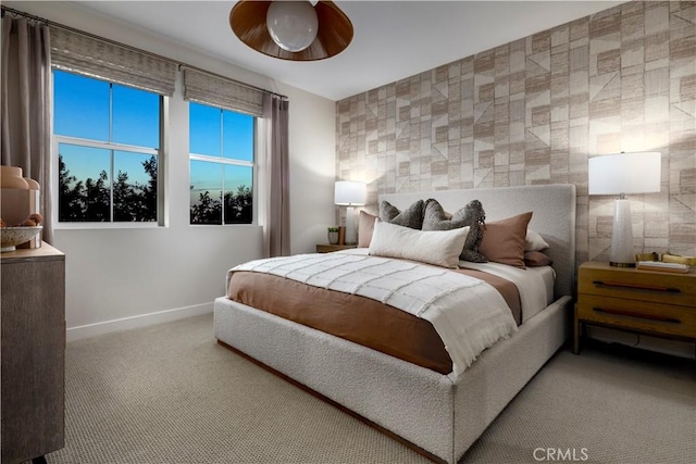 carpeted bedroom featuring baseboards