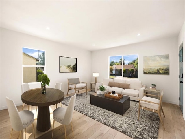 living area featuring light wood-style floors, baseboards, and recessed lighting