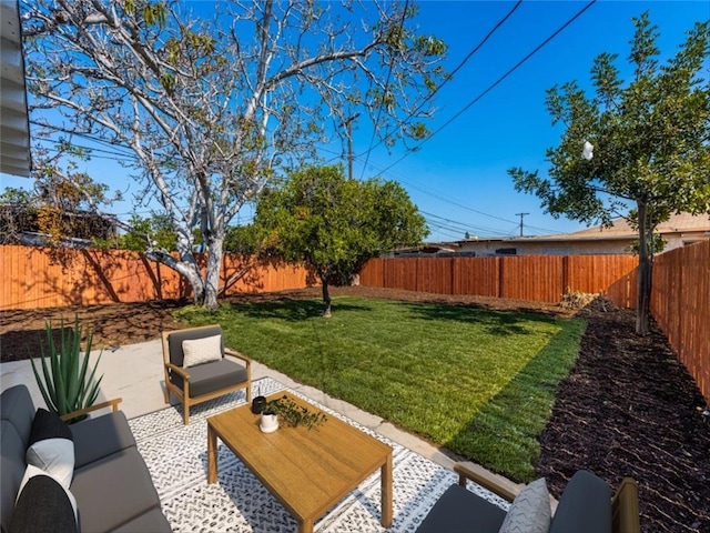 view of yard featuring a fenced backyard, a patio, and an outdoor living space