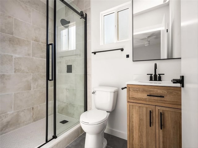 full bathroom featuring vanity, toilet, baseboards, tile patterned floors, and a stall shower