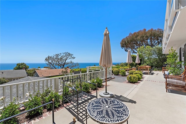 view of patio / terrace featuring a water view and a balcony