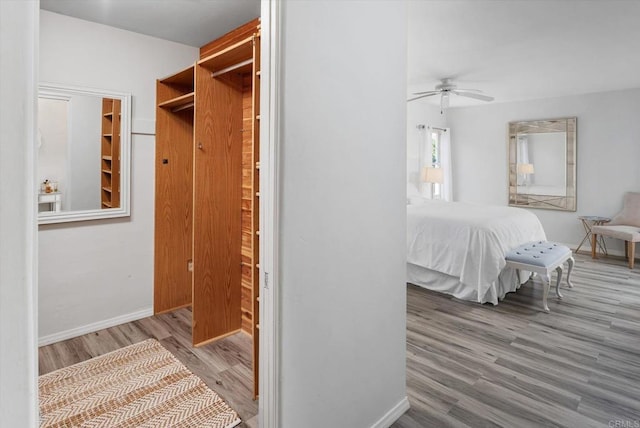 interior space featuring baseboards, ceiling fan, and wood finished floors