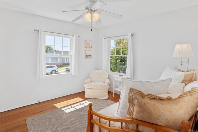 sitting room with ceiling fan and wood finished floors