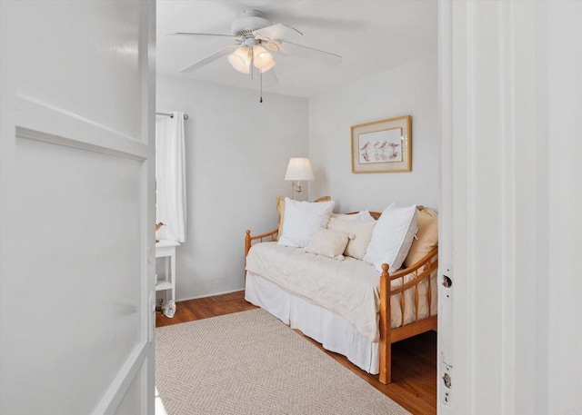 bedroom with a ceiling fan and wood finished floors