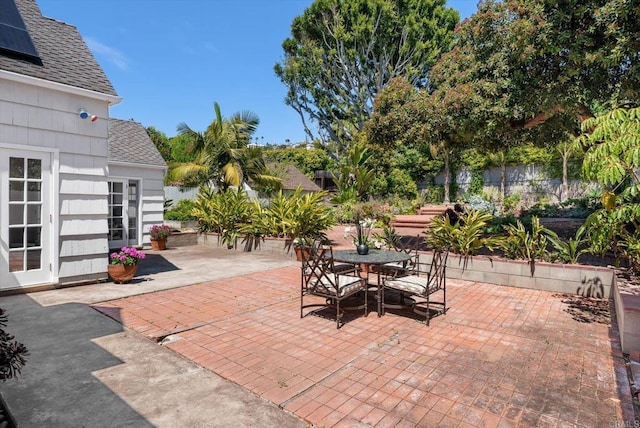 view of patio with fence and outdoor dining area