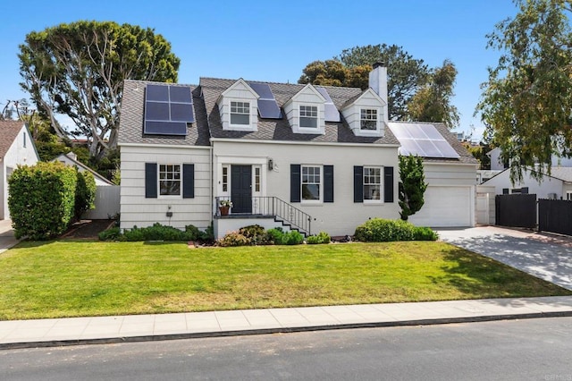 cape cod-style house with fence, a front yard, a chimney, driveway, and solar panels