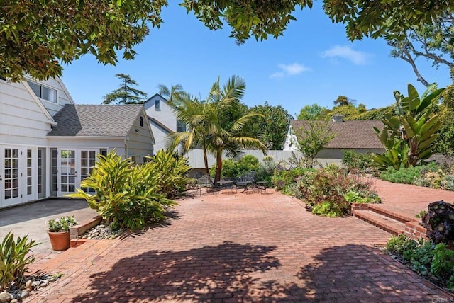 view of home's community with fence and a patio area