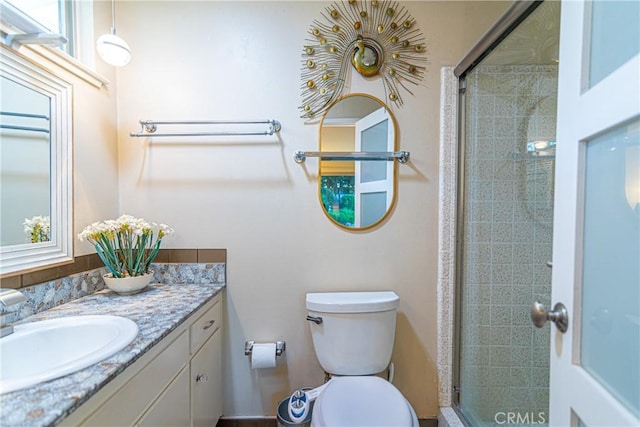 full bath with toilet, a shower stall, and vanity