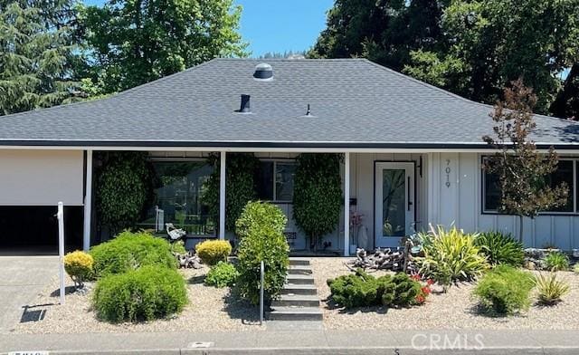 7019 Fairfield Dr, Santa Rosa, CA 95409 - view of front of home with board and batten siding, roof with shingles, a porch, and concrete driveway