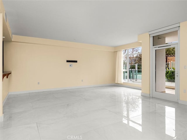 empty room with baseboards and marble finish floor