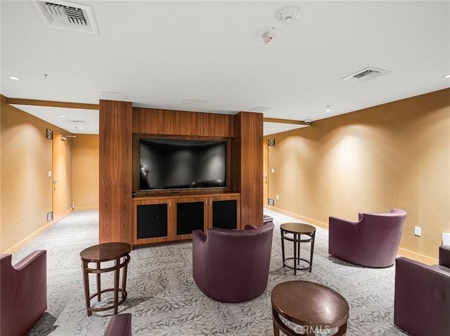 home theater room featuring carpet floors, baseboards, and visible vents